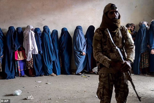 A Taliban Fighter Stands Guard As Women Wait To Receive Food Rations From A Humanitarian Aid Group In Kabul In May 2023