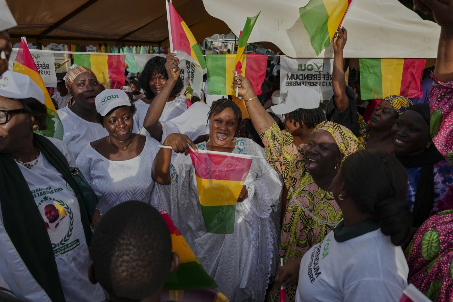 Supporters Of The Constitutional Referendum Wave Guinea Flags With Optmistic Expressions And Cheers